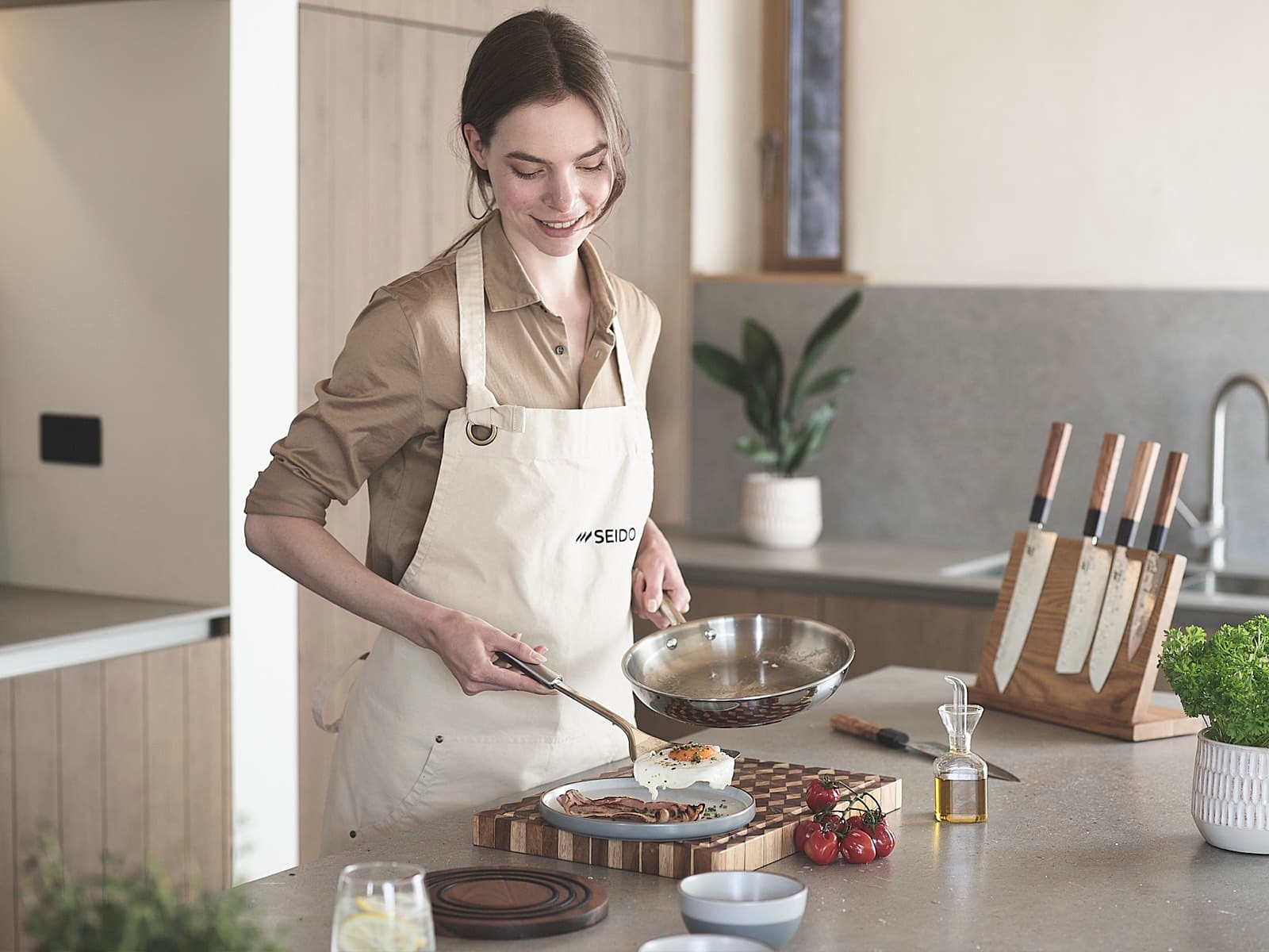 Cooking with an uncoated stainless steel frying pan in a bright kitchen