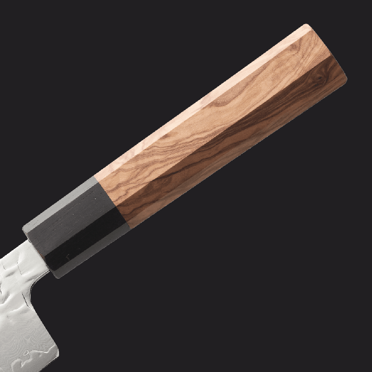 The octagonal olive wood handle of the SEIDO chef's knife